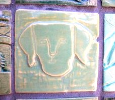 Tile of either G Washington or a dog. Located along the Mill Plain extension are 2400 tiles individually hand carved by members of the community, specifically the Hough neighborhood; many appear to have been made by children.